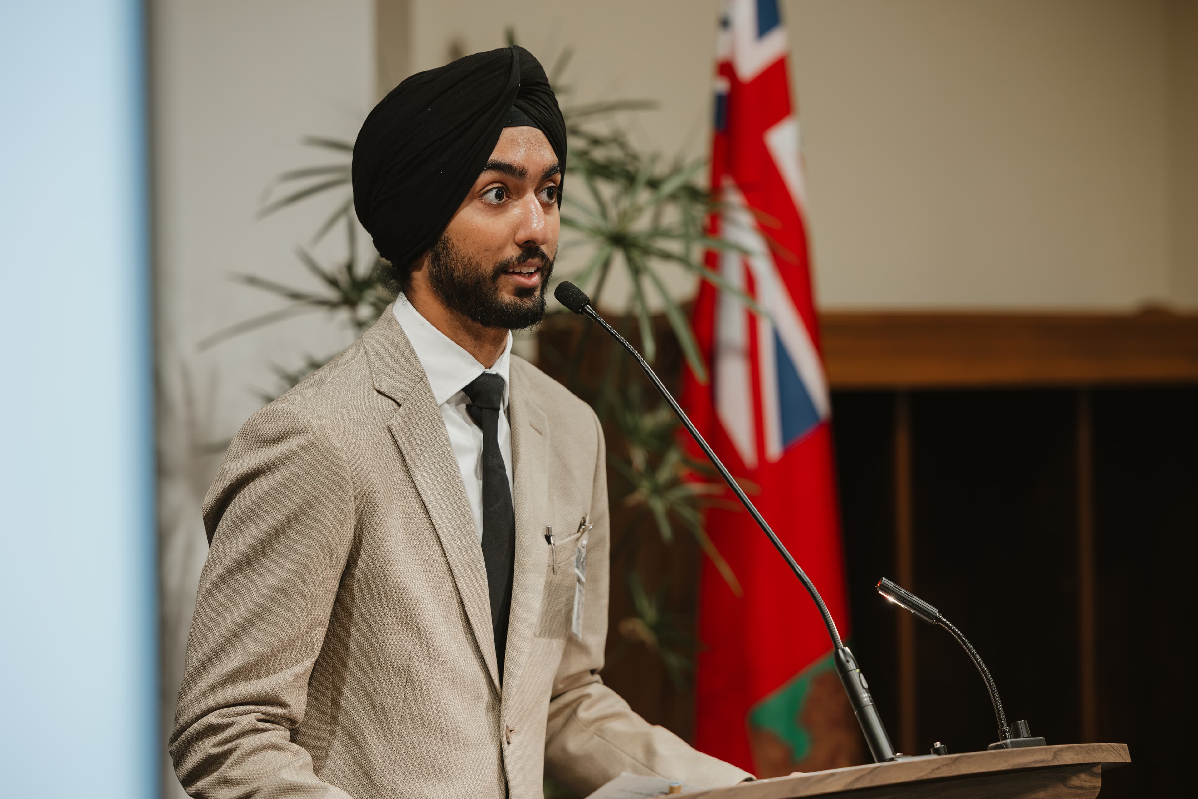 Prabhnoor Singh speaking at a podium